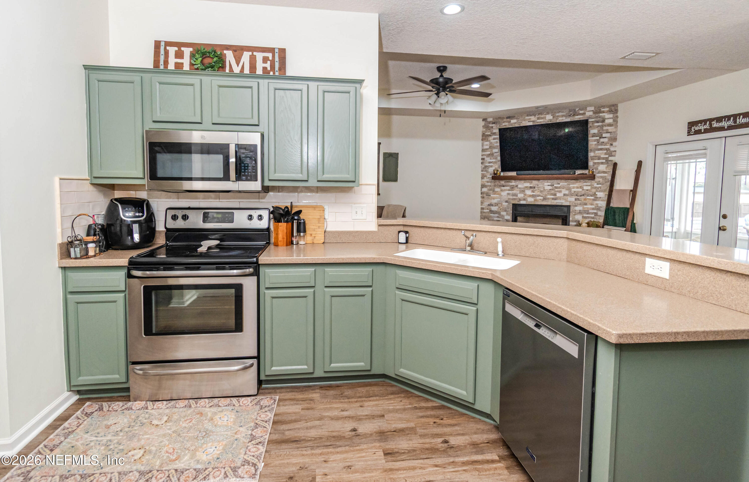 8139 Hunters Ridge South Glen St. Mary, FL 32040 - Photo 17 of 49 a kitchen with a sink stove and microwave