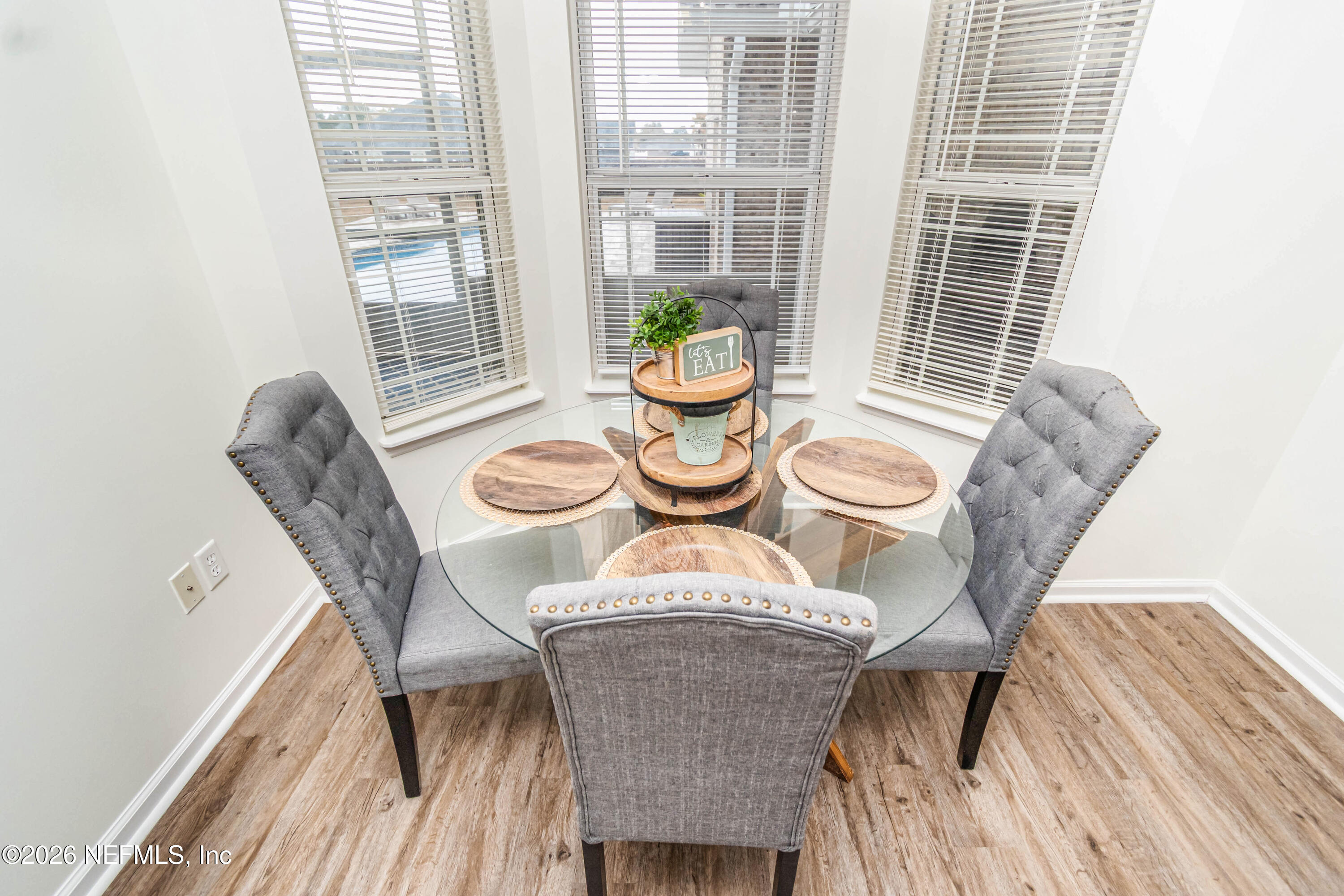 8139 Hunters Ridge South Glen St. Mary, FL 32040 - Photo 18 of 49 a view of a dining room with furniture window and wooden floor