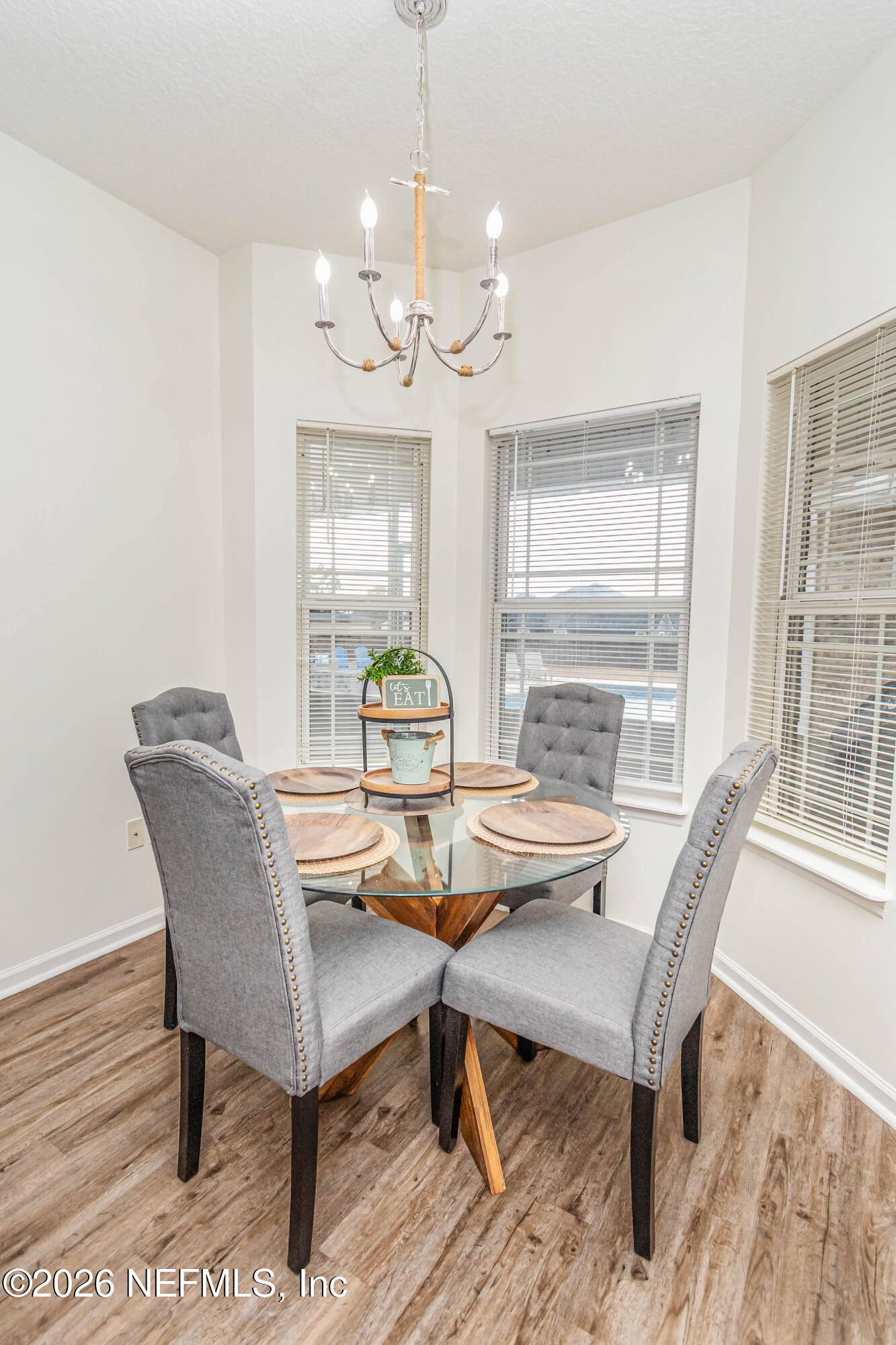 8139 Hunters Ridge South Glen St. Mary, FL 32040 - Photo 19 of 49 a view of a dining room with furniture a chandelier and wooden floor