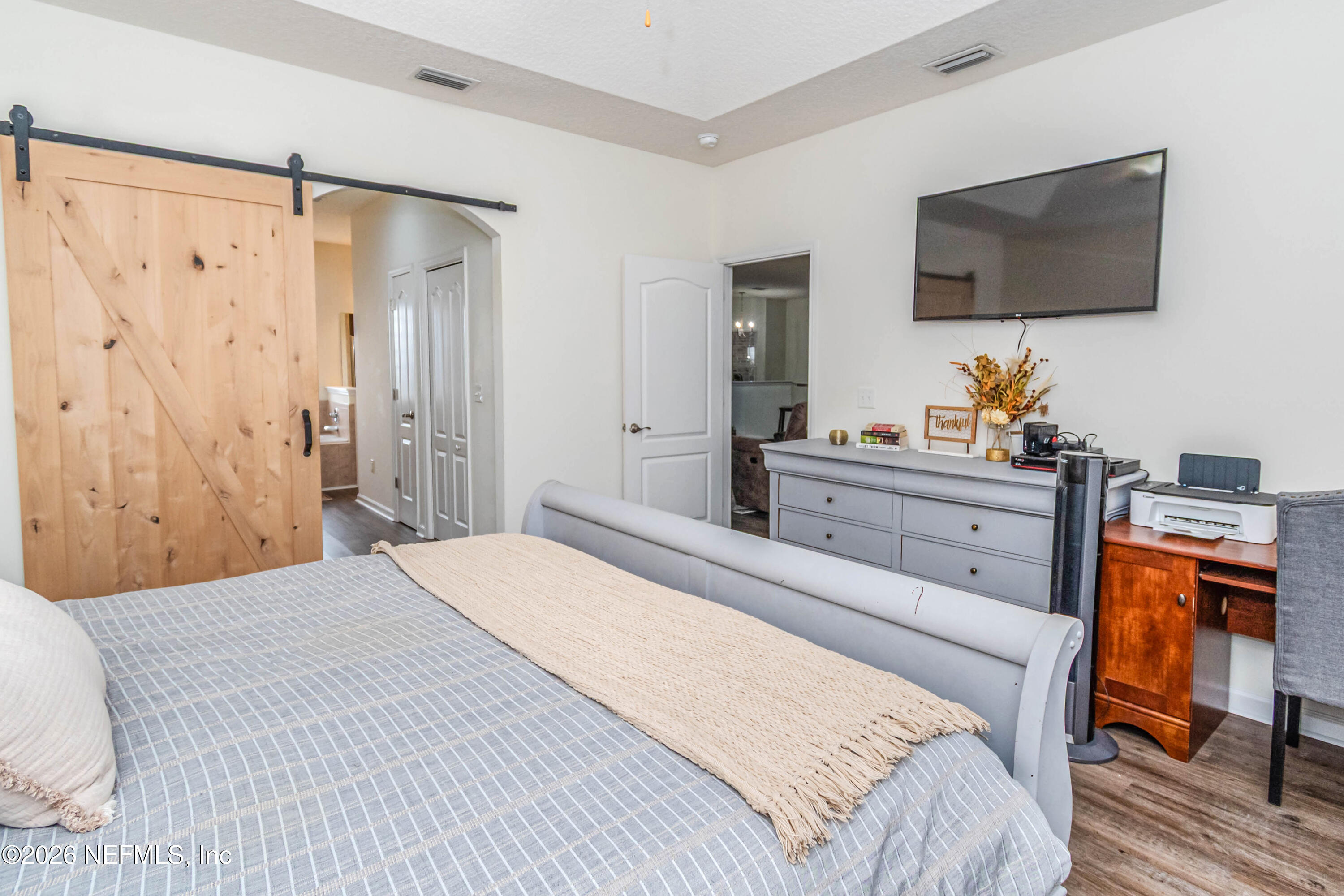 8139 Hunters Ridge South Glen St. Mary, FL 32040 - Photo 24 of 49 a bedroom with a bed and a flat screen tv