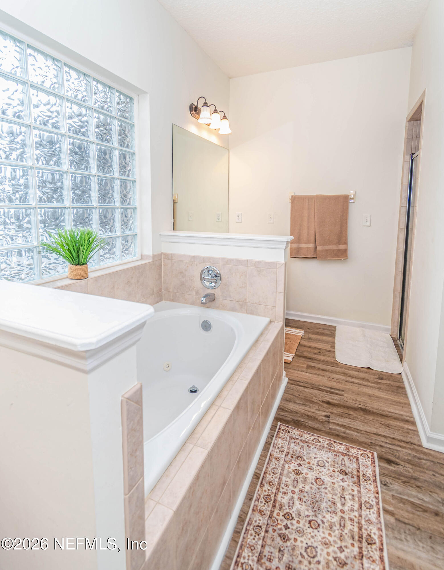 8139 Hunters Ridge South Glen St. Mary, FL 32040 - Photo 26 of 49 a bathroom with a bathtub and a shower