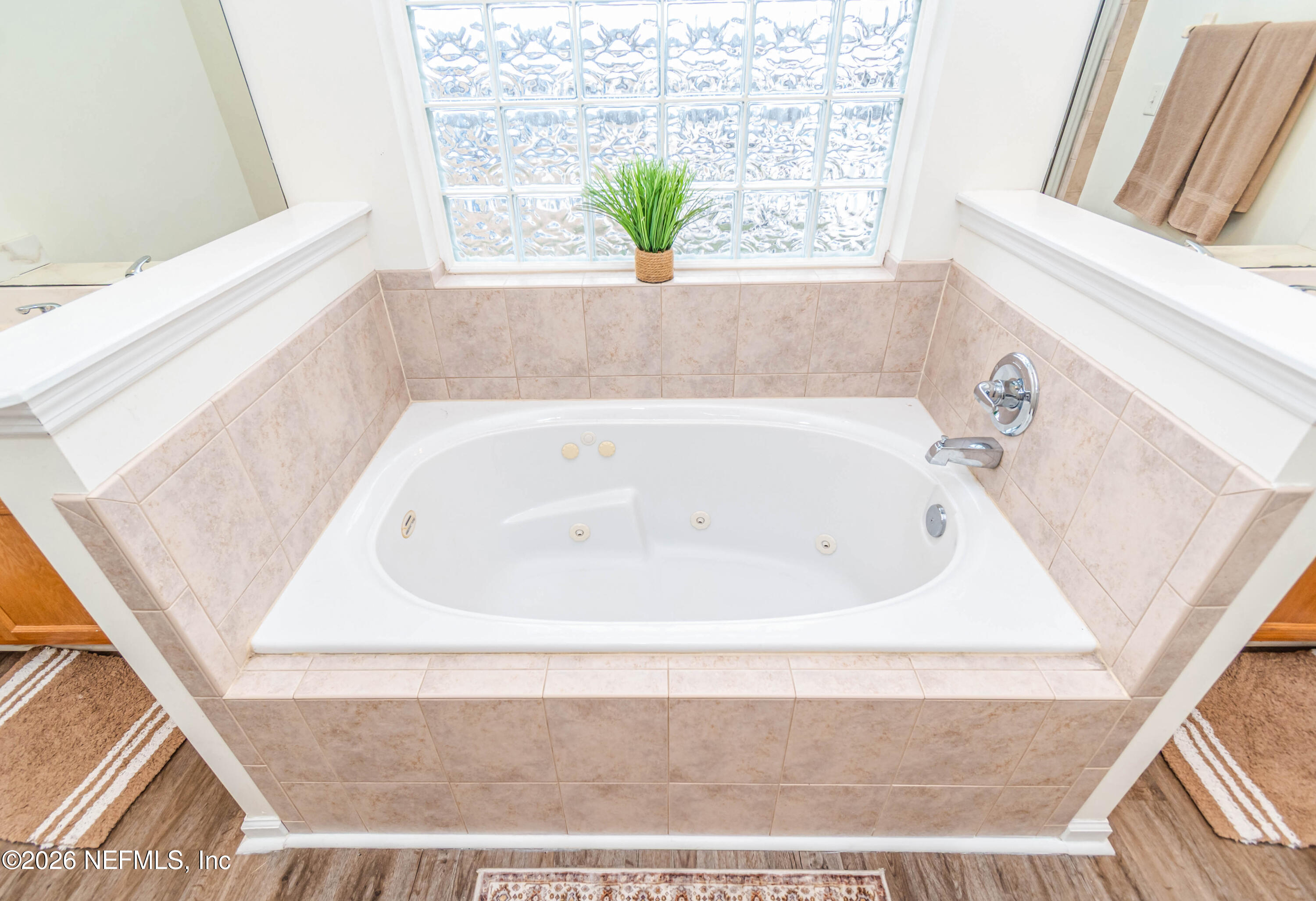 8139 Hunters Ridge South Glen St. Mary, FL 32040 - Photo 27 of 49 a white bath tub sitting in a bathroom next to a window