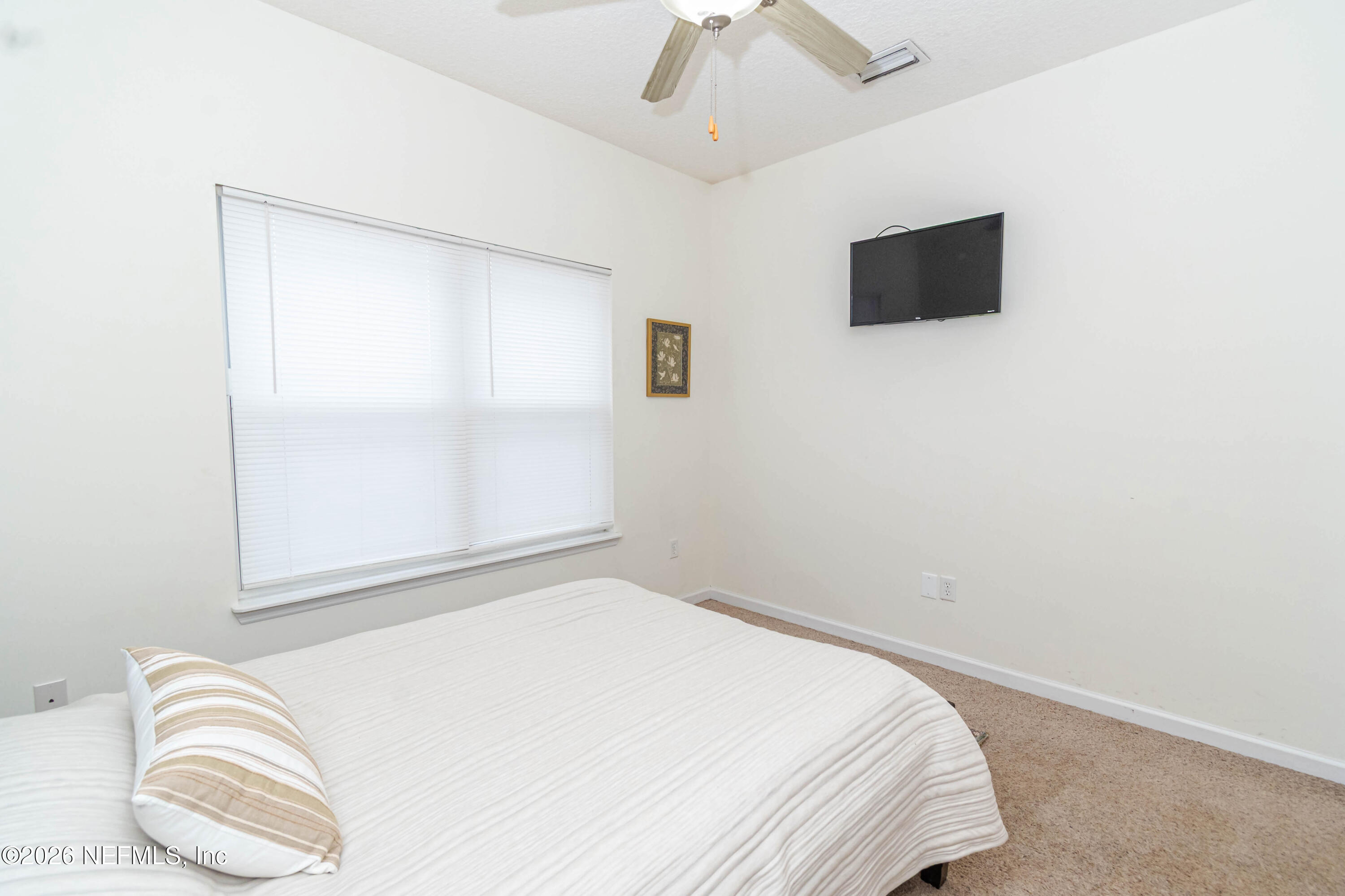 8139 Hunters Ridge South Glen St. Mary, FL 32040 - Photo 30 of 49 a bedroom with a bed and a flat screen tv