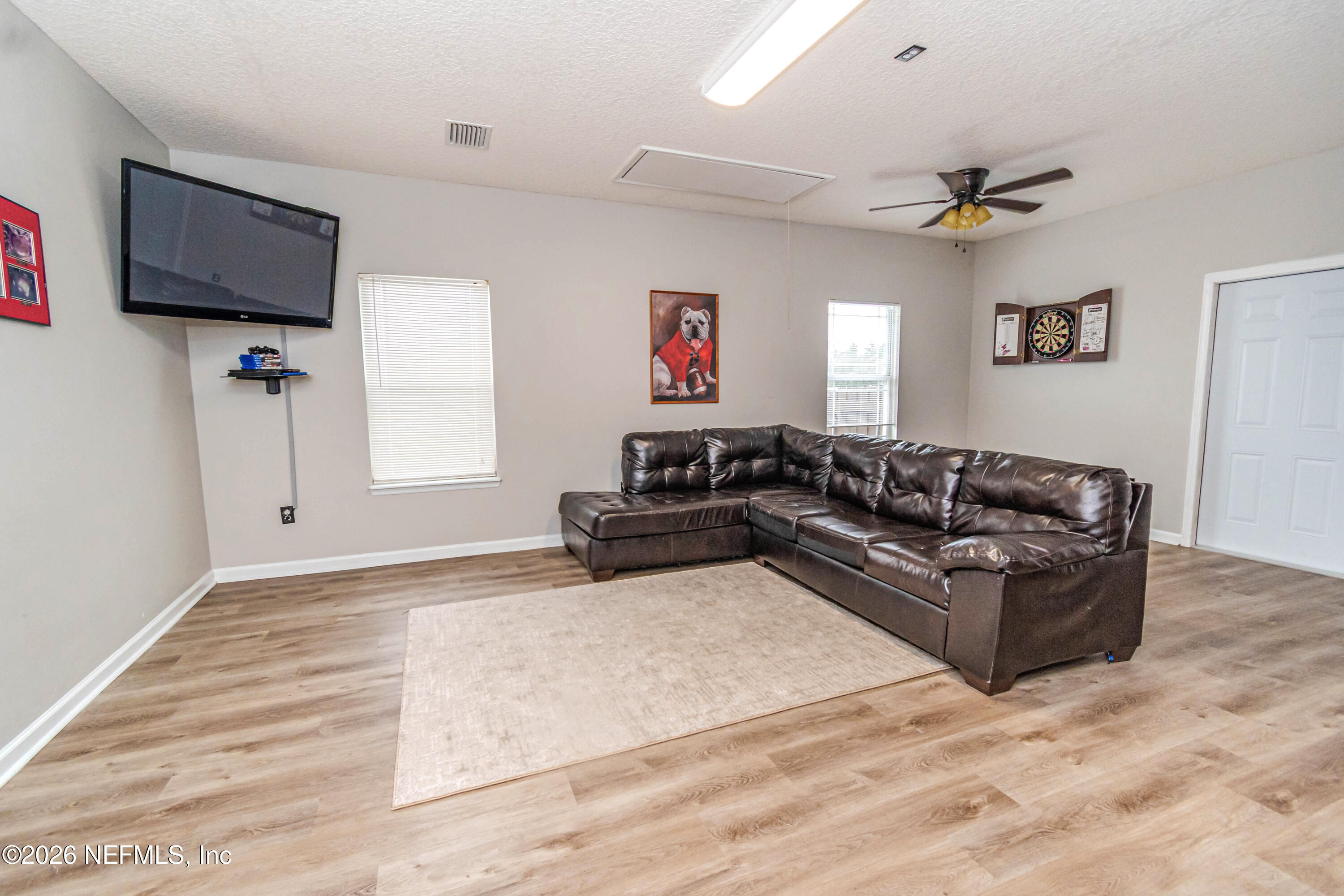 8139 Hunters Ridge South Glen St. Mary, FL 32040 - Photo 39 of 49 a living room with furniture and a flat screen tv