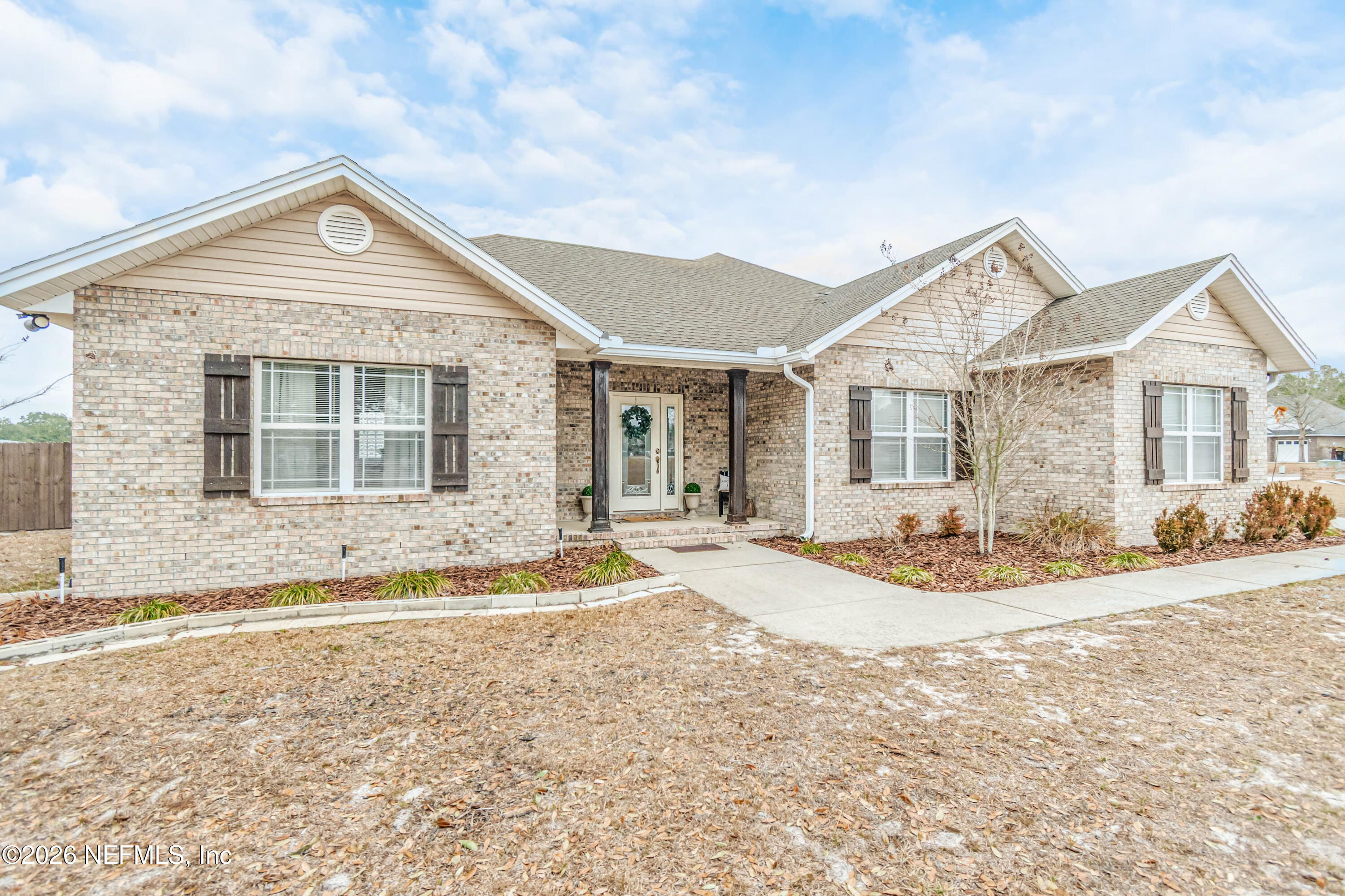 8139 Hunters Ridge South Glen St. Mary, FL 32040 - Photo 4 of 49 a front view of a house with a yard and garage