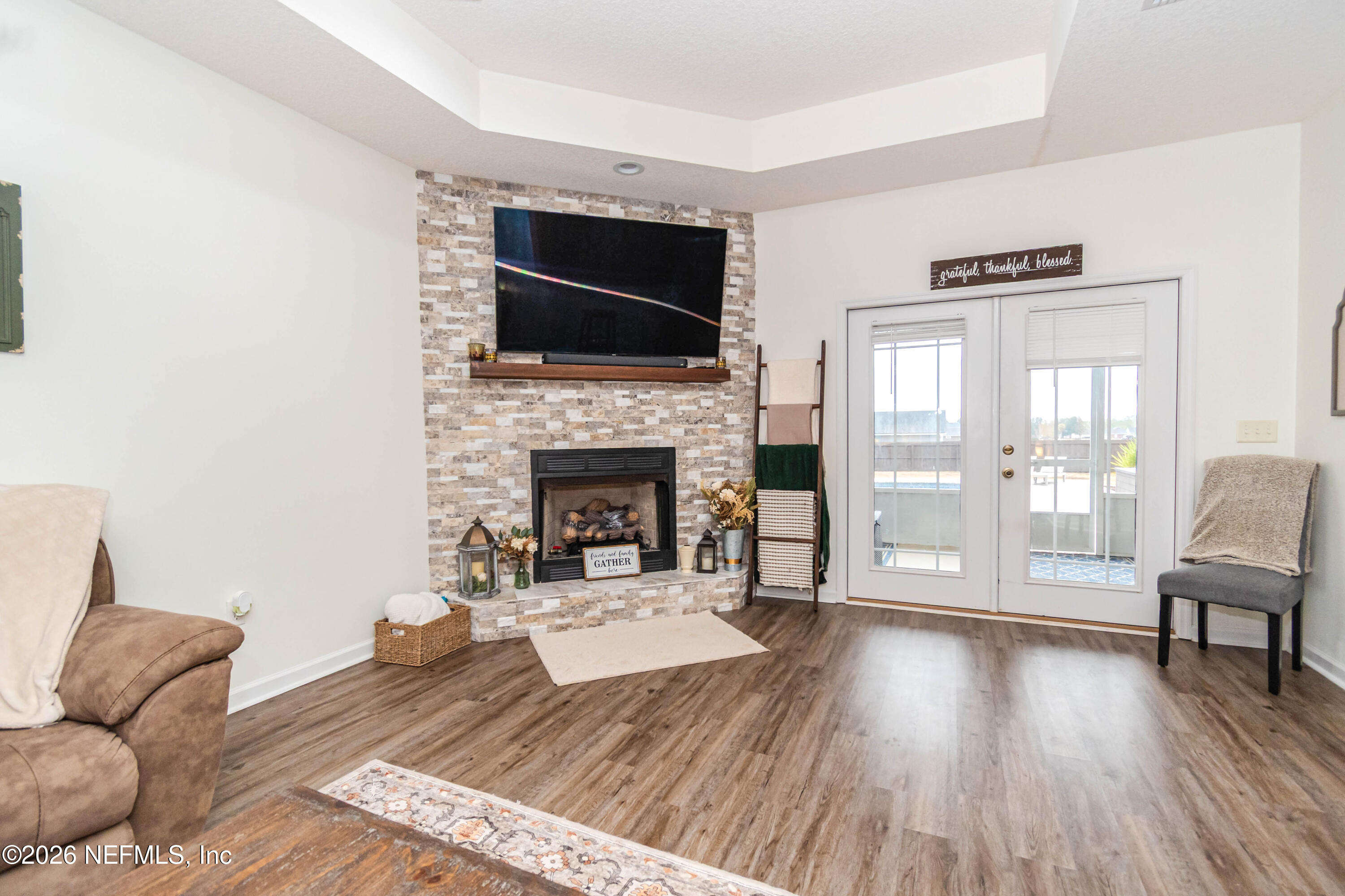 8139 Hunters Ridge South Glen St. Mary, FL 32040 - Photo 8 of 49 a living room with furniture fireplace and flat screen tv