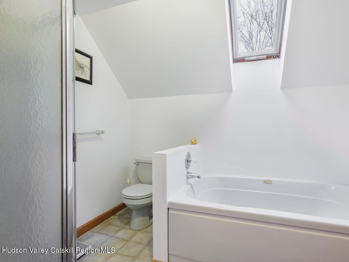 831 North Chodikee Lake Road Highland, NY 12528 - Photo 16 of 31 a bathroom with a toilet and a bathtub