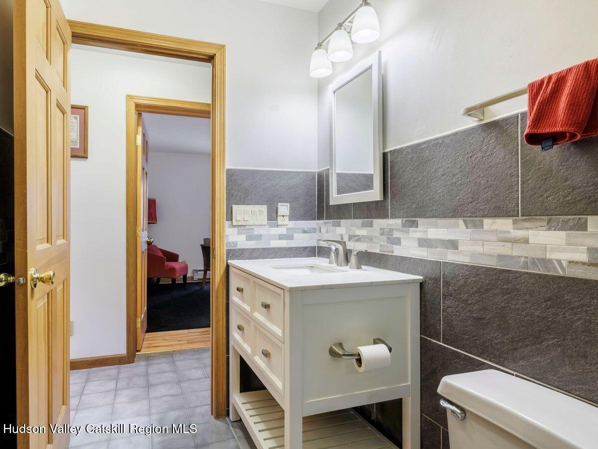 831 North Chodikee Lake Road Highland, NY 12528 - Photo 18 of 31 a bathroom with a sink and a mirror