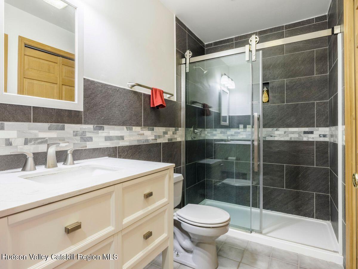 831 North Chodikee Lake Road Highland, NY 12528 - Photo 23 of 31 a bathroom with a sink and a mirror