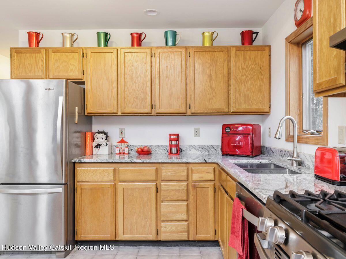 831 North Chodikee Lake Road Highland, NY 12528 - Photo 4 of 31 a kitchen with stainless steel appliances a refrigerator and a stove