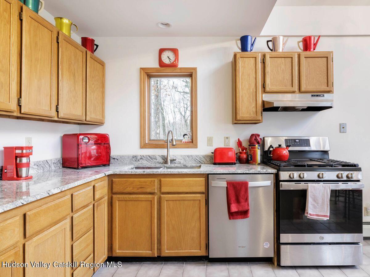 831 North Chodikee Lake Road Highland, NY 12528 - Photo 5 of 31 a kitchen with stainless steel appliances granite countertop a sink and cabinets