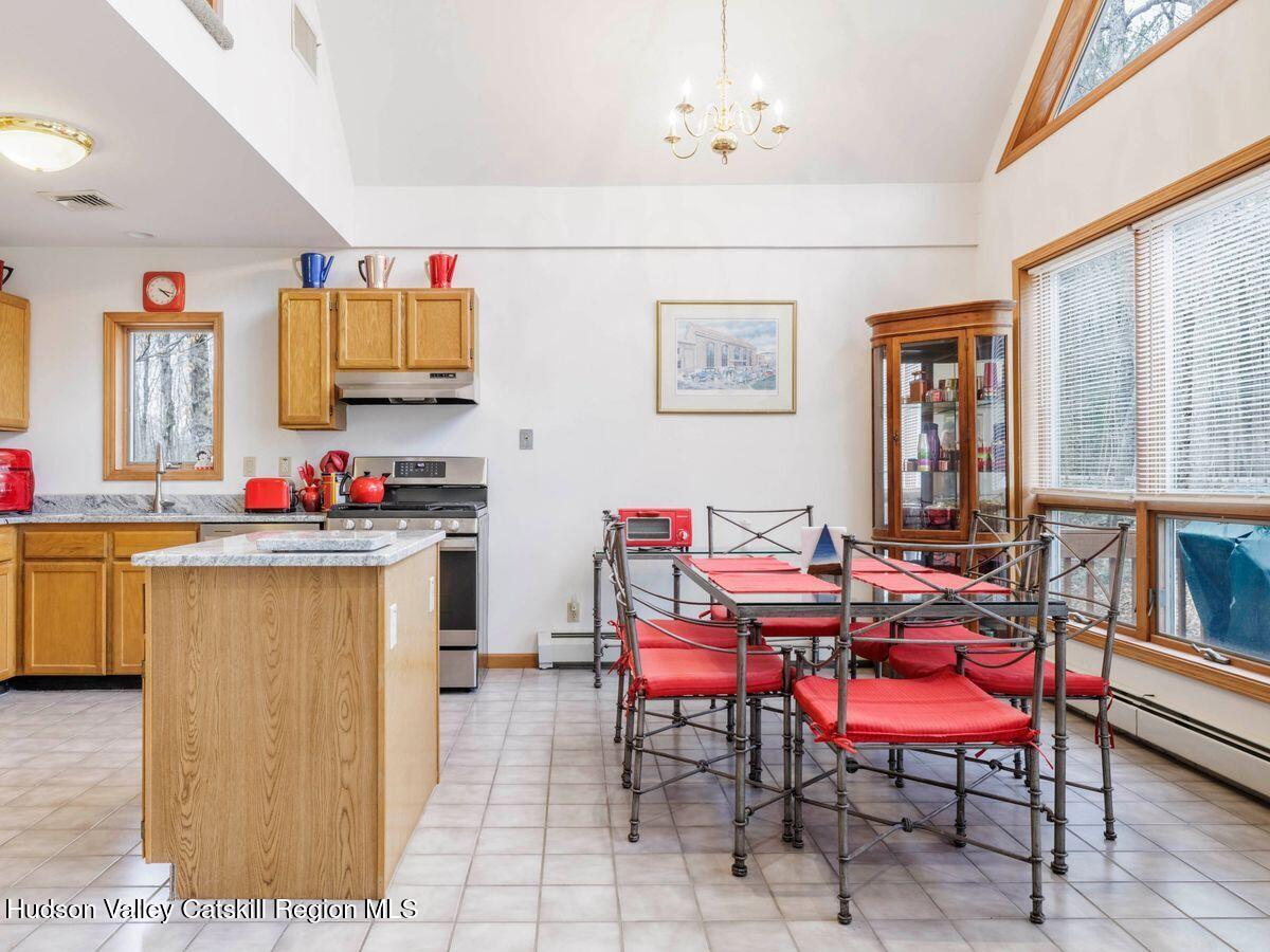 831 North Chodikee Lake Road Highland, NY 12528 - Photo 6 of 31 a view of kitchen with stainless steel appliances granite countertop a dining table and chairs with wooden floor
