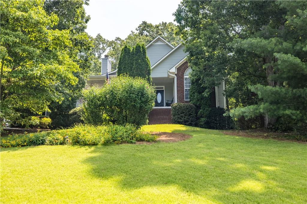 a view of a house with pool and a trees