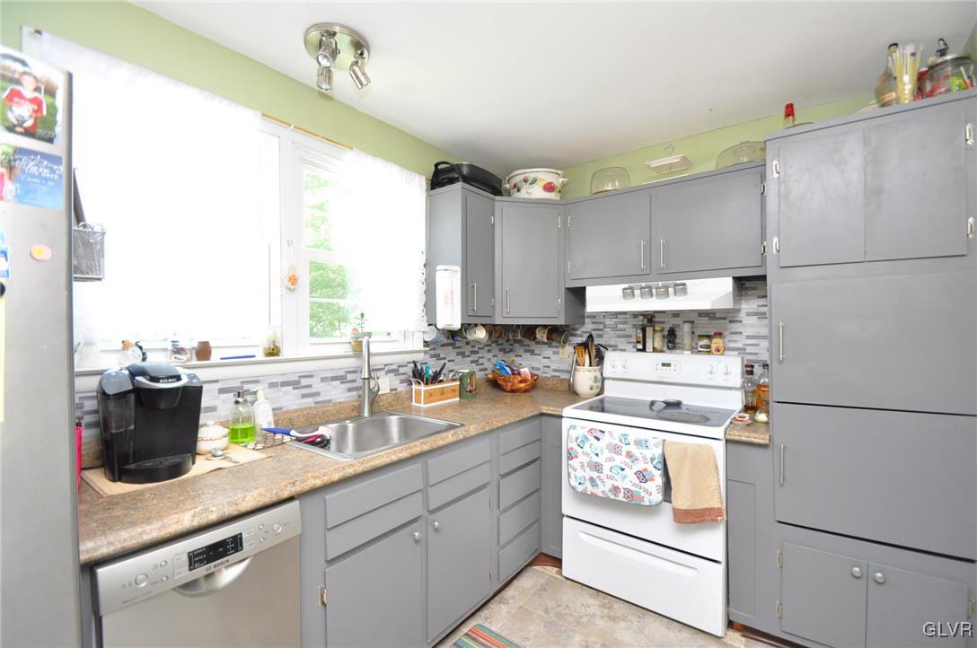 37 Ridge Avenue Telford, PA 18969 - Photo 8 of 18 a kitchen with a refrigerator a stove a sink dishwasher and white cabinets with wooden floor