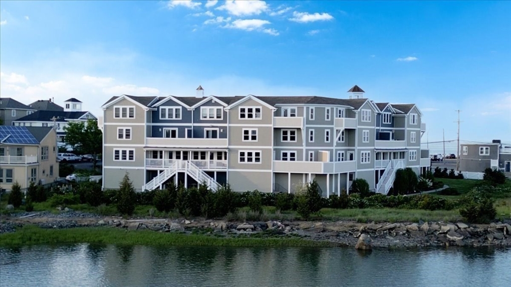 7 Bay Street, Unit 3 Hull, MA 02045 - Photo 2 of 40 a front view of a building with lake view and a lake view