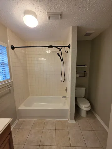 a bathroom with a shower a toilet and a shower