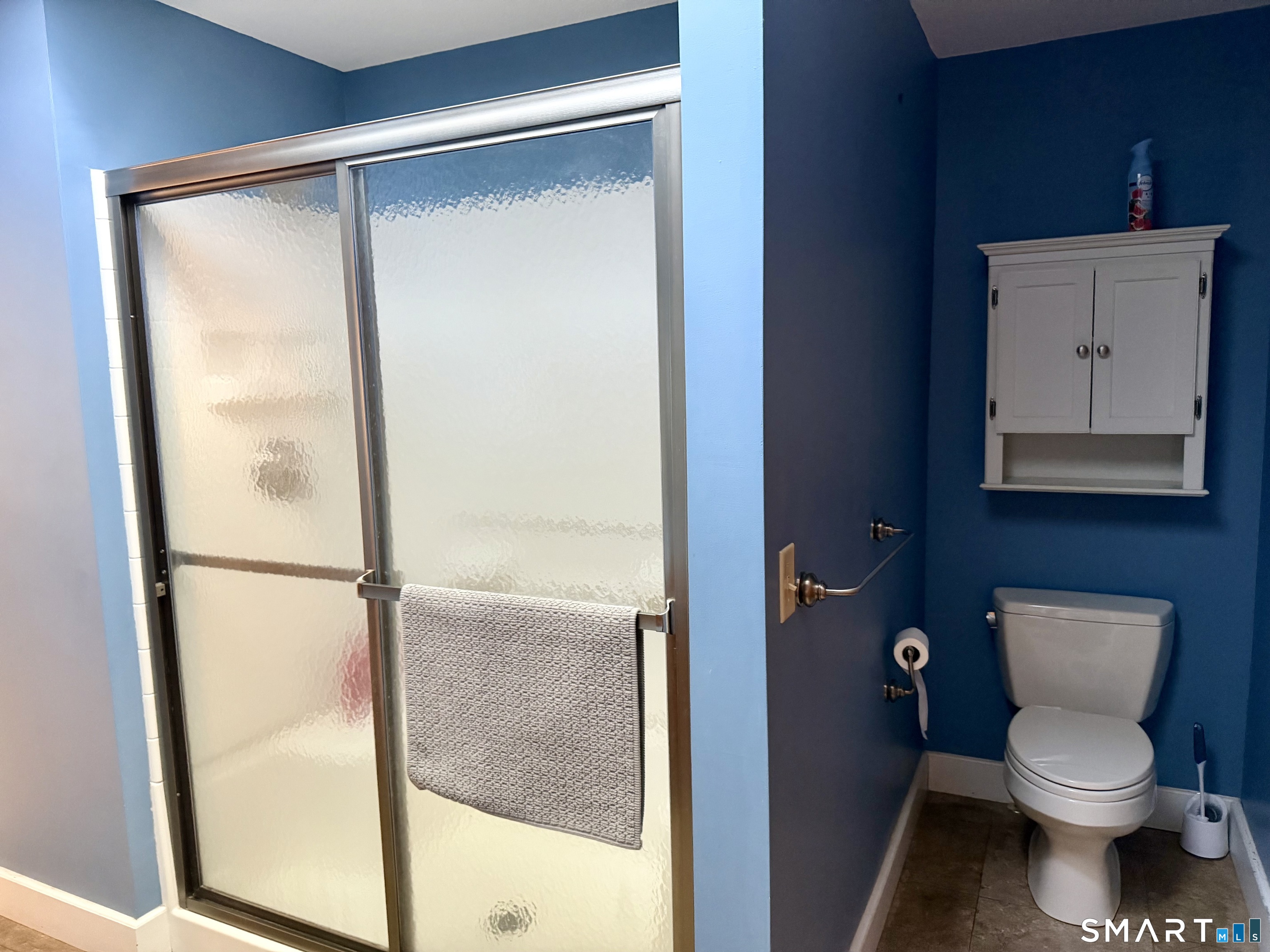 204 Pine Hollow Road Killingly, CT 06241 - Photo 14 of 20 The full bathroom at 204 Pine Hollow Road offers a spacious step-in shower, practical storage and a clean, comfortable design-another convenient feature of this easy one-level waterfront home.
