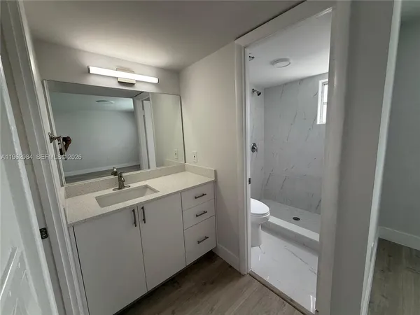 a bathroom with a double vanity sink mirror and toilet