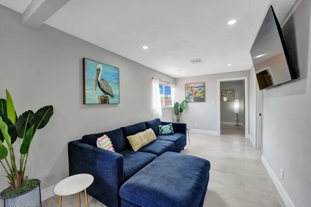 a living room with furniture and a painting on the wall