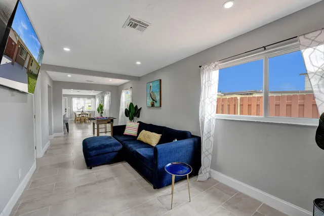 a living room with furniture fireplace and rug