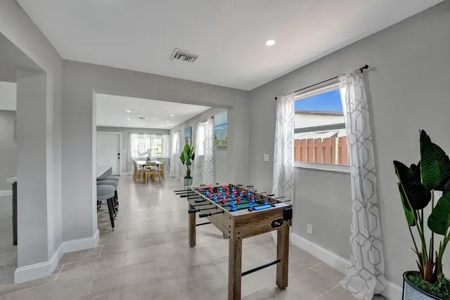 a hallway with dining table and chairs
