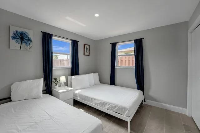 a bedroom with a large bed and a window