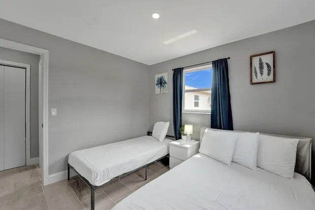 a bedroom with two beds and painted walls