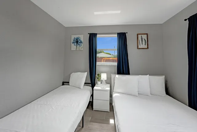 a bedroom with a bed and window