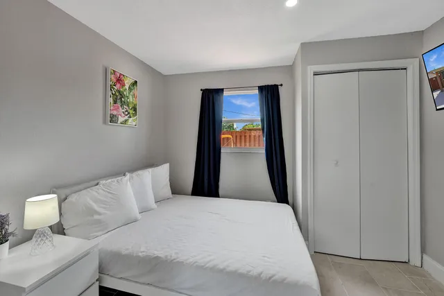 a bedroom with a bed and a painting on the wall
