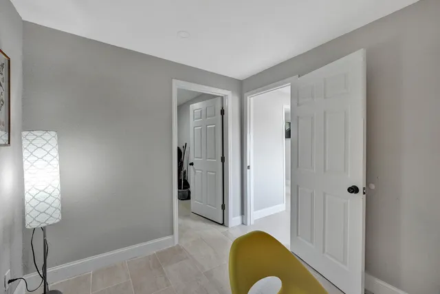 a bedroom with a bed and painting on the wall