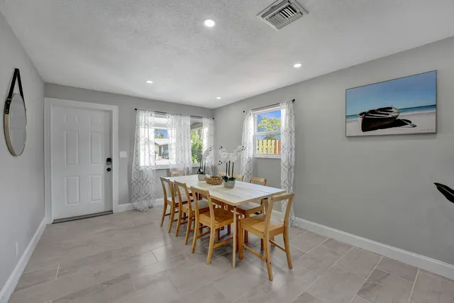 a view of a dining room with furniture and window