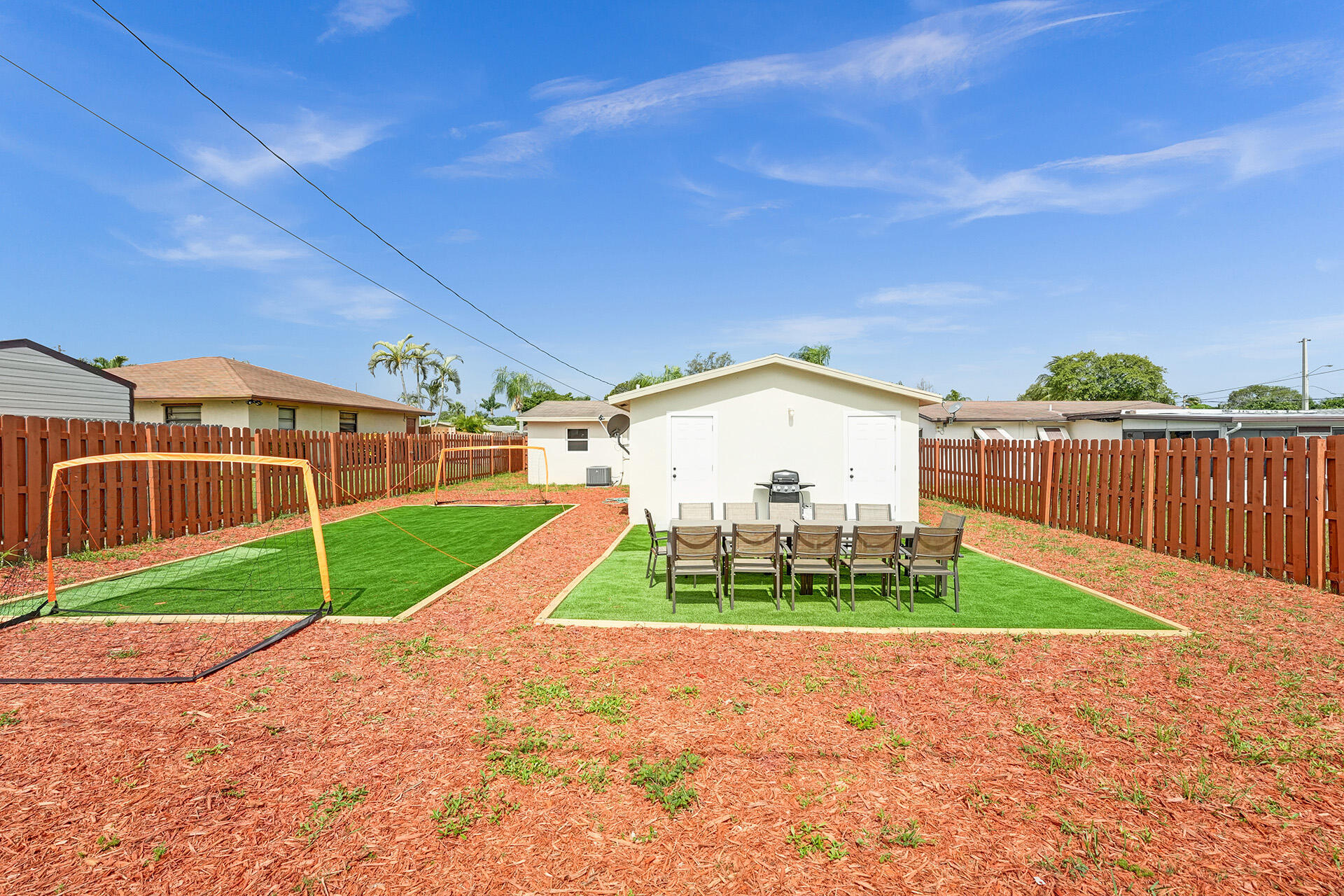 337 Southwest 8th Avenue Delray Beach, FL 33444 - Photo 47 of 48 a view of a back yard with flower plants and wooden fence