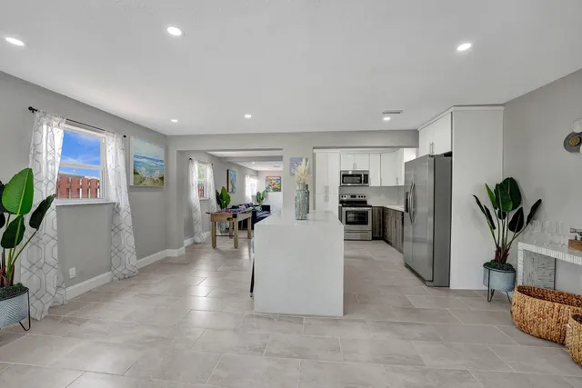 a living room with furniture and a potted plant