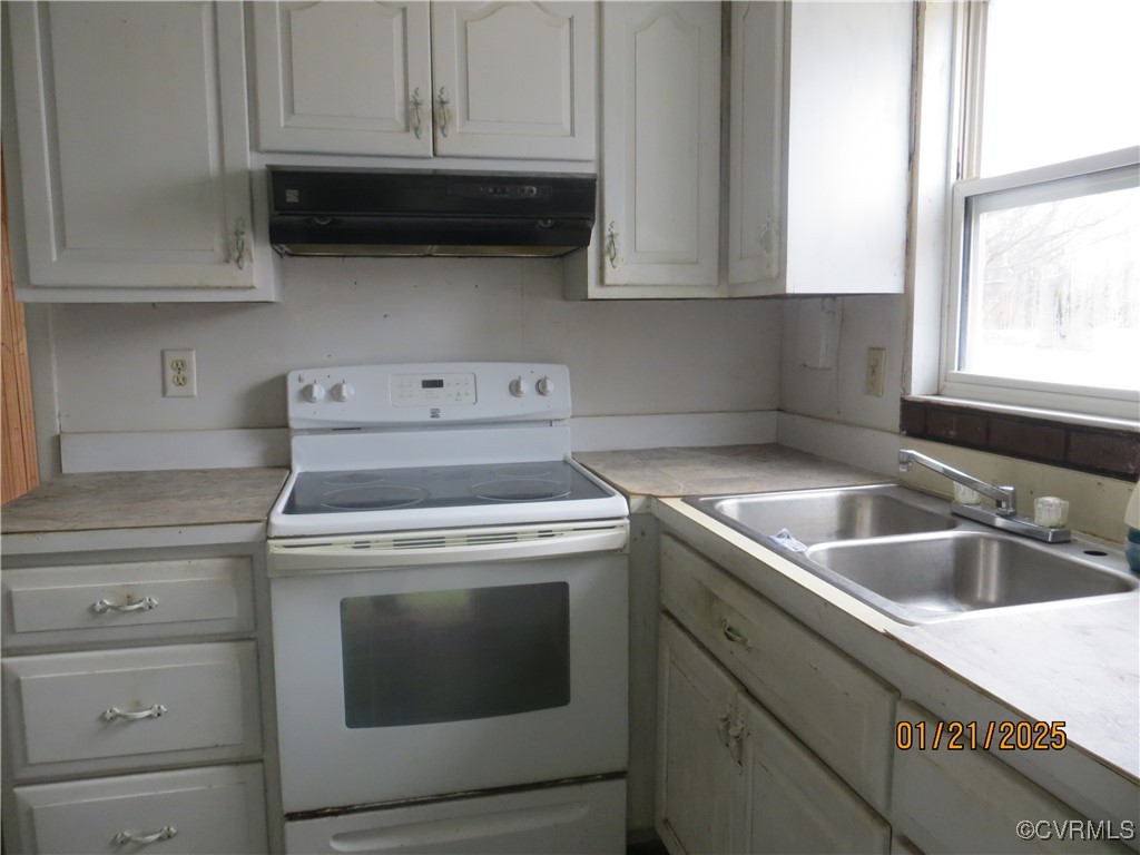 3042 Lara Road Lancaster, VA 22503 - Photo 5 of 15 a kitchen with granite countertop white cabinets and a stove top oven