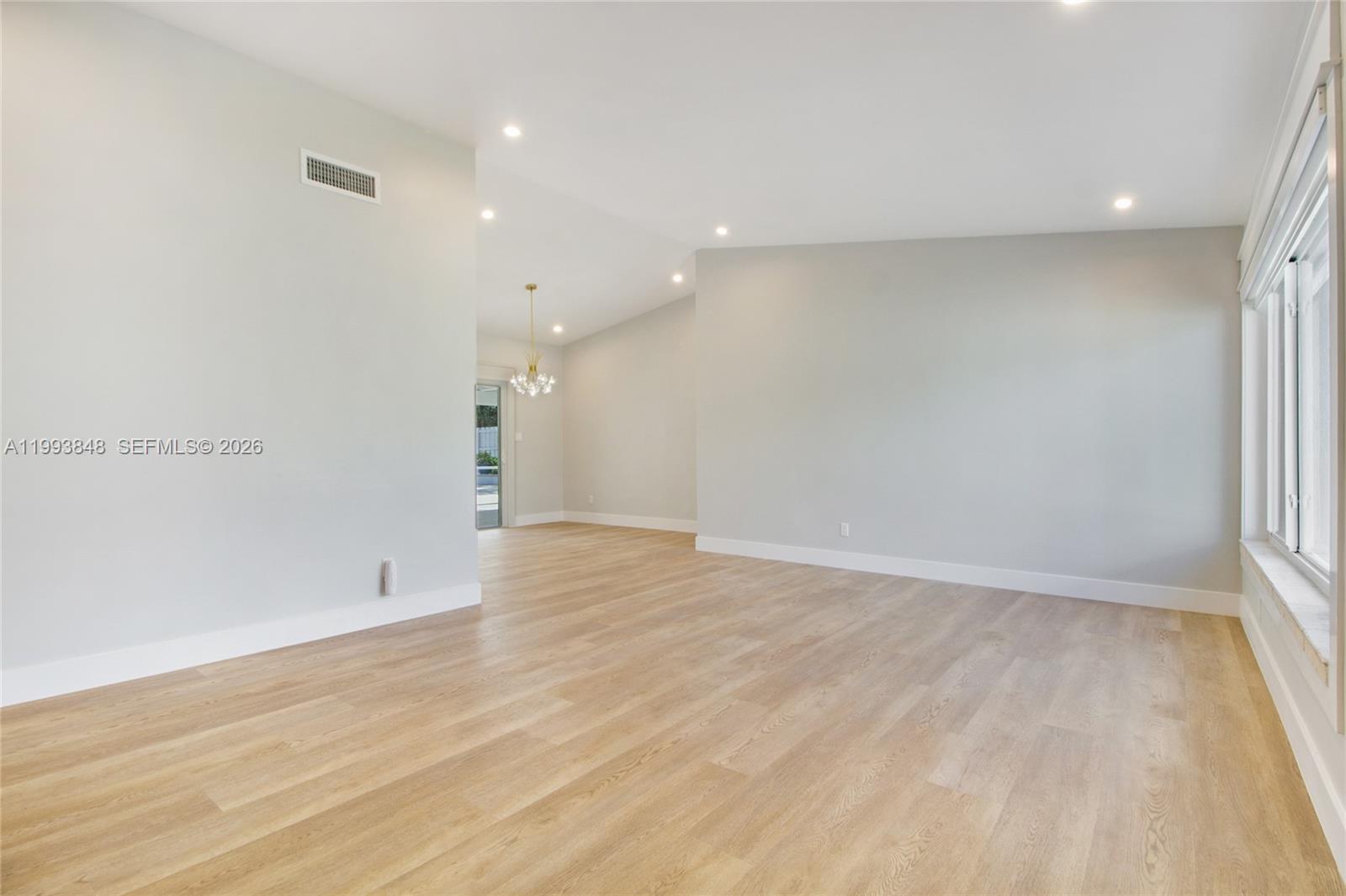 11011 Southwest 110th Road Miami, FL 33176 - Photo 6 of 15 wooden floor in an empty room with a window