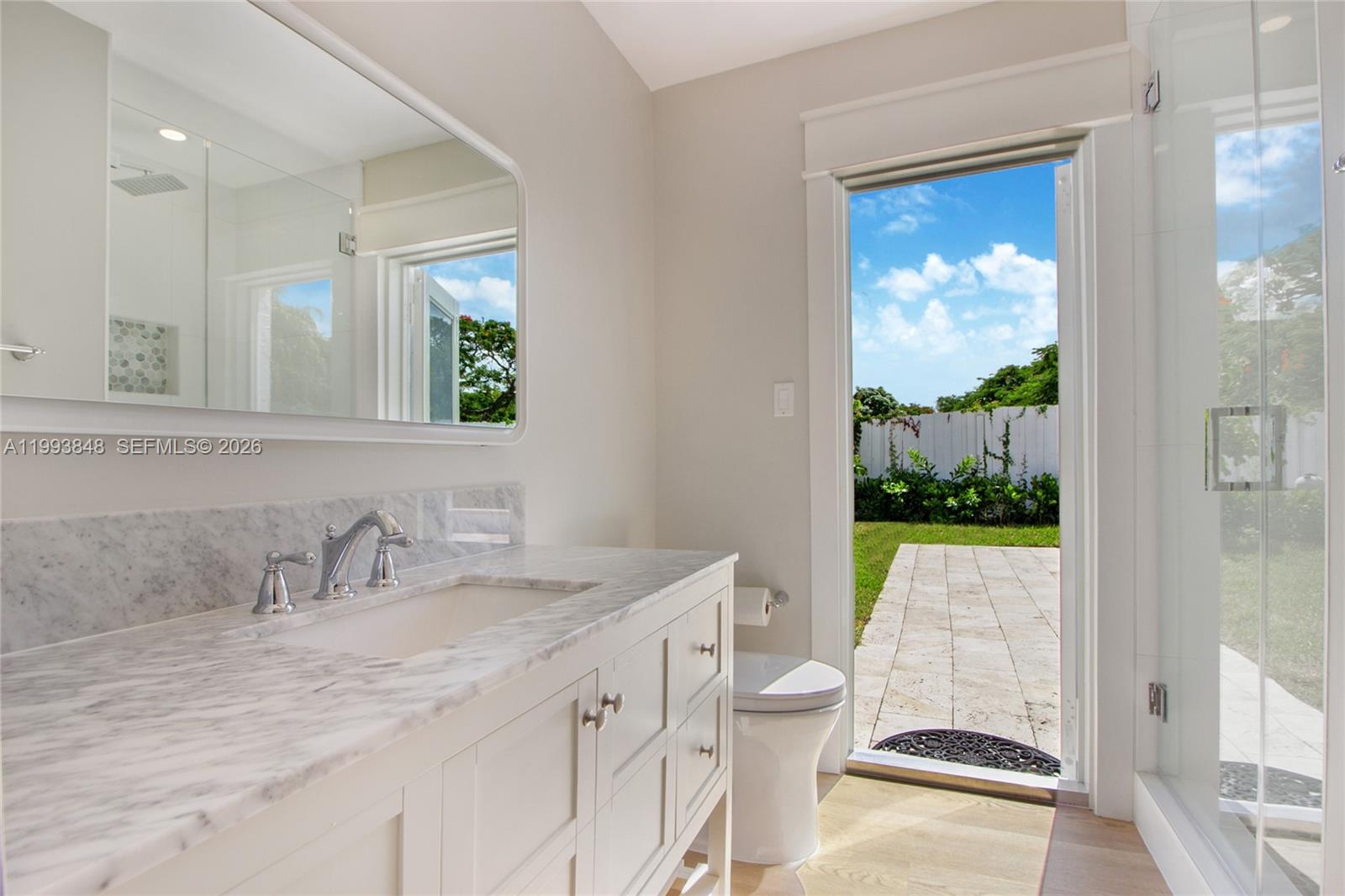 11011 Southwest 110th Road Miami, FL 33176 - Photo 9 of 15 a bathroom with a granite countertop sink mirror vanity and toilet