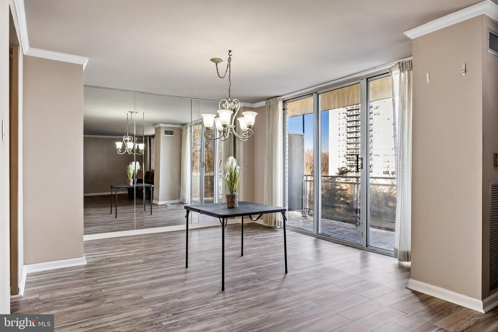 1840 Frontage Road, Unit 404 Cherry Hill, NJ 08034 - Photo 13 of 28 a view of a room with wooden floor fireplace and chandelier