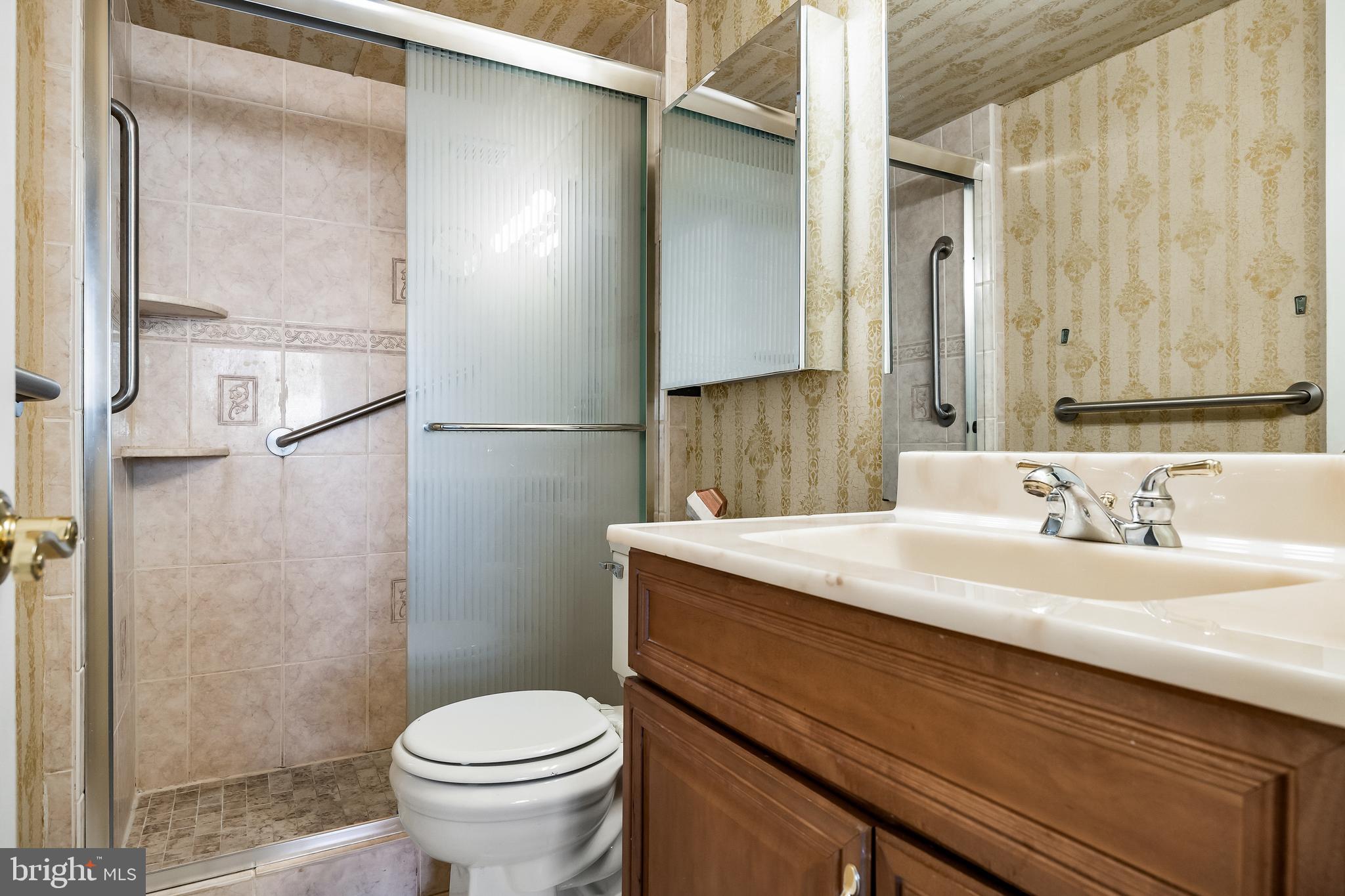 1840 Frontage Road, Unit 404 Cherry Hill, NJ 08034 - Photo 21 of 28 a bathroom with a granite countertop sink toilet and a mirror