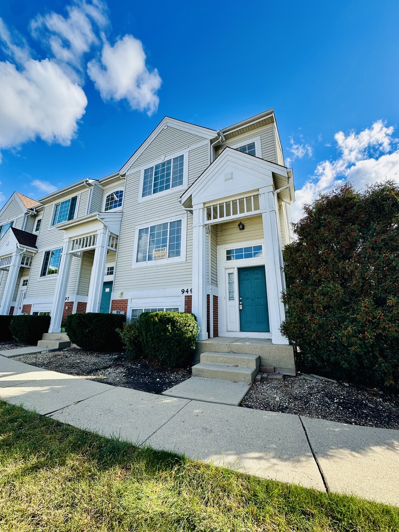 9499 Harrison Street, Unit 9499 Des Plaines, IL 60016 - Photo 1 of 17 a front view of a house with a yard
