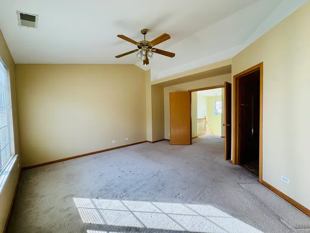 a view of a livingroom with a ceiling fan and window