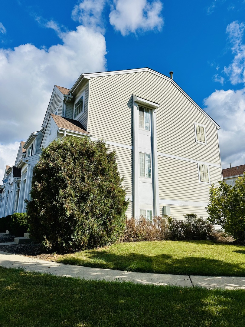 9499 Harrison Street, Unit 9499 Des Plaines, IL 60016 - Photo 2 of 17 a front view of a house with a garden