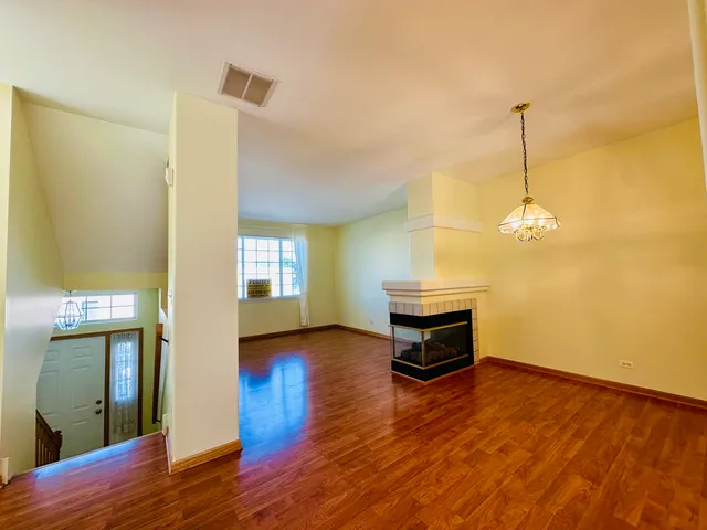 a view of a room with wooden floor
