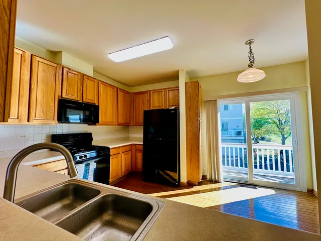 a kitchen that has a sink cabinets counter space and a window