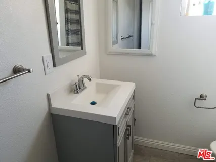 a bathroom with a toilet sink and shower