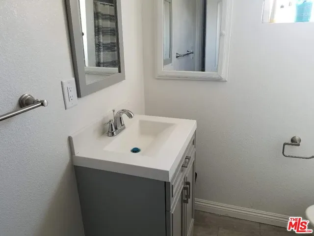 a bathroom with a toilet sink and shower