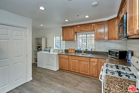 a view of hallway with wooden floor
