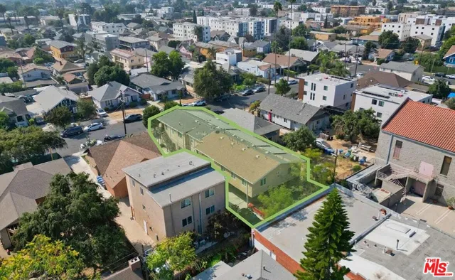 an aerial view of residential houses with outdoor space
