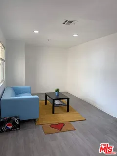 a kitchen with stainless steel appliances granite countertop a sink and a refrigerator