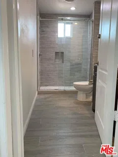 a bathroom with a toilet and a shower