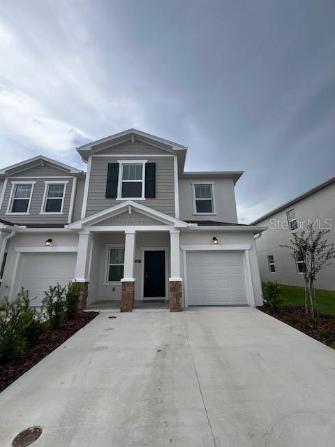 2691 Skyline Loop Kissimmee, FL 34758 - Photo 1 of 27 a front view of a house with a yard and garage